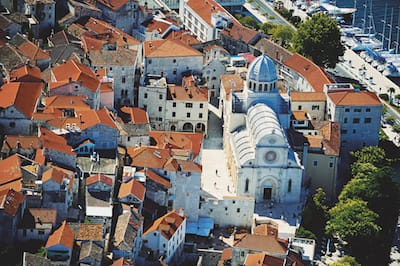 aerial view of an ancient mediterranean cathedral with surrounding buildings